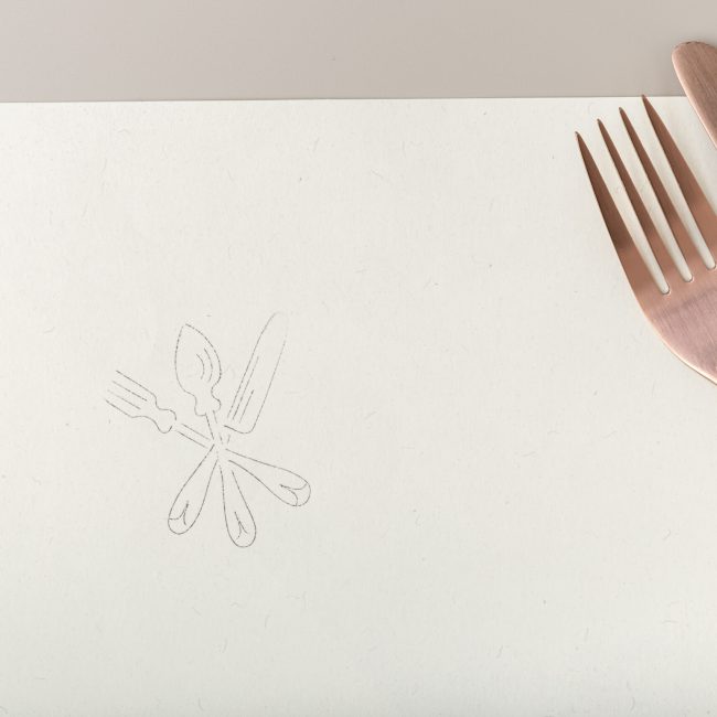 Menu background. Copper Fork and knife on Recycled paper. Mock up Copy space